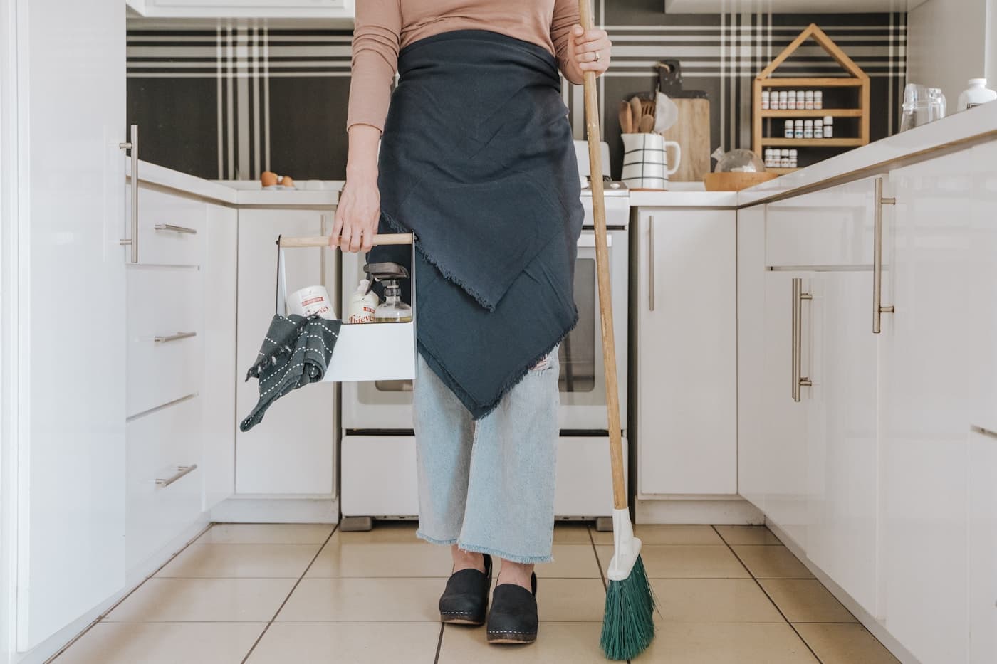 Professional cleaner tidying a bright Scottsdale kitchen